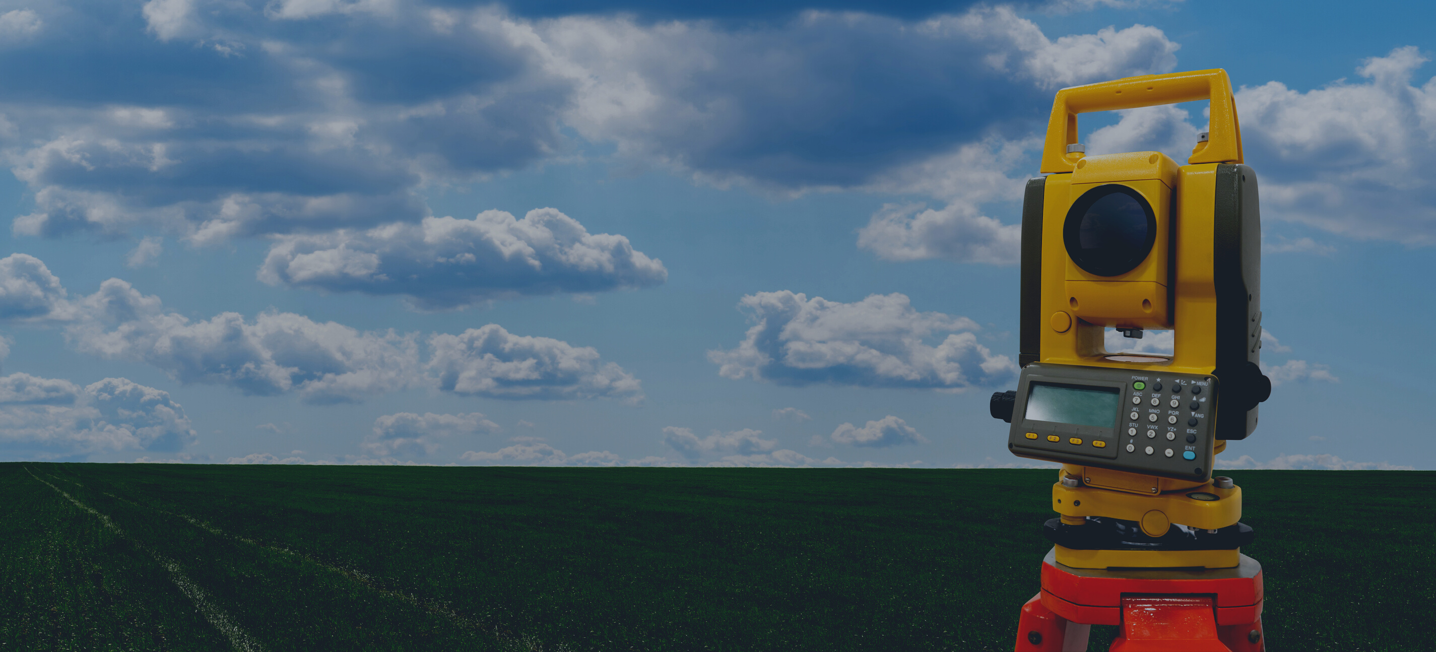 Theodolite (total positioning station) on a background of green field